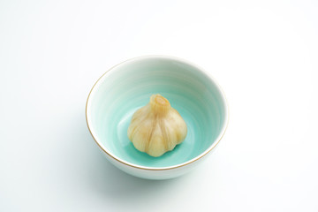 Sugar garlic and blue green ceramic bowl on white background