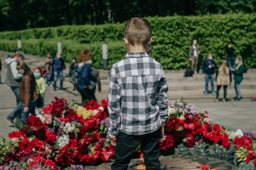 Kiev, Ukraine, May 09, 2020: people take part in the celebration of the memory of loved ones who died in World War II in the Park of Eternal Glory. Celebration of Victory Day during COVID-19 pandemic