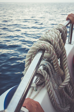 Cropped Image Of Hands Holding Boat Railing