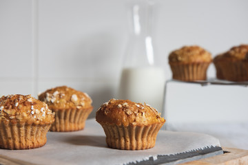 Fresh homemade delicious carrot muffins decorated with oat flakes and brown sugar on rustic table