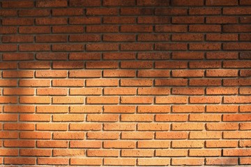 Red brick wall upper part on the shade lower part on the sun. background photo copy space 