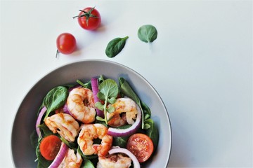 salad with shrimps and vegetables. photo isolate on grey top view copy space 