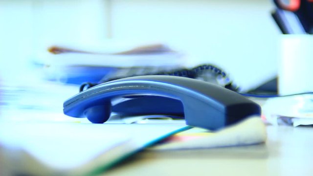 Very angry, unpredictable male, person, operating with telephone, waiting for a call, ending it. Office. Close up. Bright light.