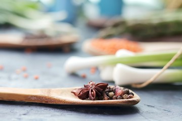 Spicy herbs, asparagus, lemons, seasonings, lentils on the kitchen table for preparing healthy homemade food from organic products