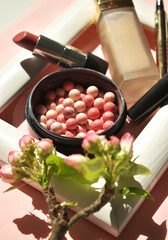 A set of decorative cosmetics on a pink background. Top viev. Flat lay.