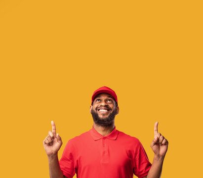 Courier Man Pointing Fingers Up At Free Space, Studio Shot