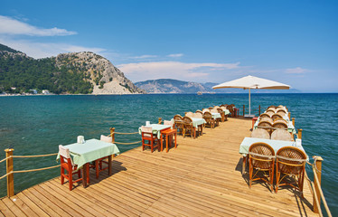 Traditional greek street cafe with flowers.