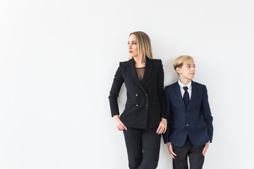 Parenting, family and single parent concept - A happy mother and teen son smiling on white background.