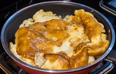 Delicious fried Thai omelet in a pan homemade cooking