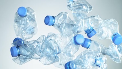 Super Slow Motion Shot of Flying Empty Plastic Bottles on Light Gradient Background at 1000fps. - Powered by Adobe