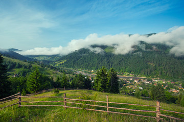 Fototapeta na wymiar View of foggy summer day in mountains