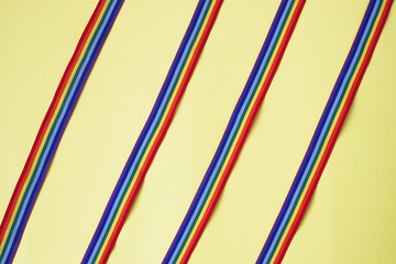 repeating strips rainbow ribbon on a yellow background. thanks to the medical staff