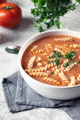 Tomato soup with fusilli pasta in the bowl