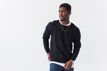 Youth street fashion concept - Portrait of confident sexy black man in stylish sweatshirt on white...