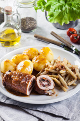 Pork rolls stuffed with vegetables served with potatoes