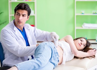 Fototapeta premium Pregnant woman visiting radiologyst for ultrasound