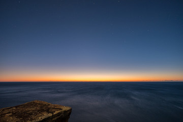 dawn horizon, ocean and rock platform