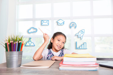Primary school girl reading and writing book with graphic icon ideas