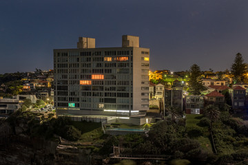 houses and apartments overlooking the ocean at night