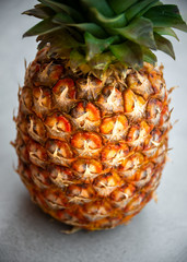 Ripe pineapple on grey background, isolated tropical fruit