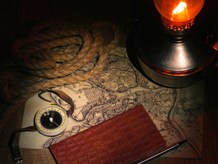 preparation for travel on an old map with a compass a dark background