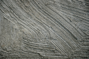 Rough gray surface of weathered plaster and cement