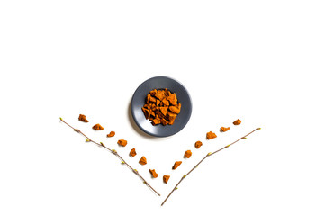 chaga mushroom. composition of small dry pieces of birch tree fungus chaga in a round plate and...