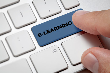 Online Learning Business:White computer keyboard and technology background. Male hand pressing...