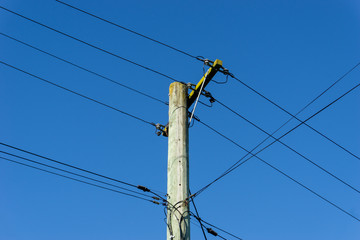 High voltage power lines in a blue sky