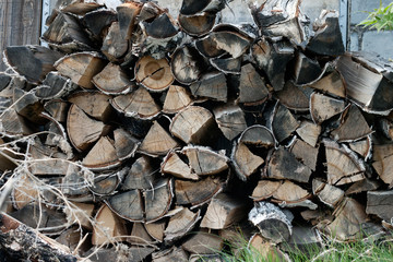 Village firewood from birch logs. The concept of resources for survival, rural life.