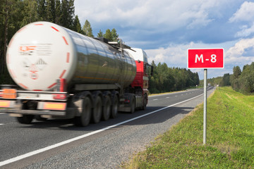 A truck with a tank driving on the M8 road in the Vologda region