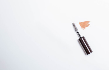 Makeup. The girl in a black mitten paints on a white background makeup.