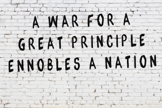 Black painted inscription of smart quote on white brick wall