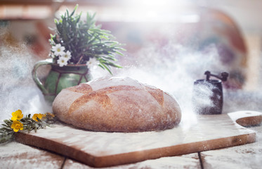 Freshly baked traditional bread on wooden table