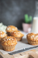Fresh homemade delicious carrot muffins decorated with oat flakes and brown sugar on rustic table