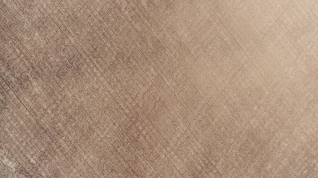 Aerial Drone top-down zenithal view of empty agricultural arid field and textures