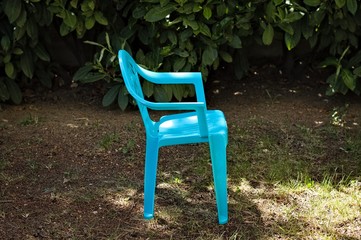 An isolated blue little chair for kids in the garden (Pesaro, Italy, Europe)