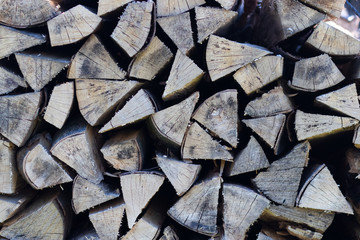 A pile of firewood for heating in winter in rural areas