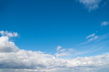 Naklejka na ściany i meble Background with blue sky with lots of white clouds