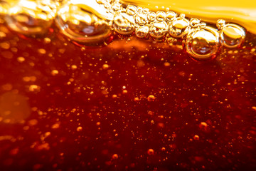 Blurred background in soft focus with cola with bubbles.