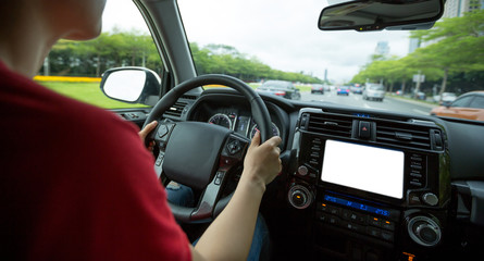 Fototapeta na wymiar People hands holding steering wheel while driving car on city road