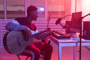Musician and making music concept - African american male sound producer working in recording...