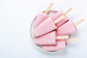 Homemade strawberry ice cream and ice on a plate on the table. Summer healthy eating concept with copy space.
