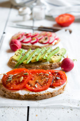 Vegetable sandwiches with radish, avocado and tomato, healthy vegan snack