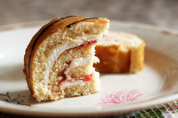 A roll cake with cream and cherries. Summer dessert with berries