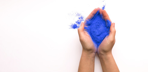Blue paint for annual Holi celebration in hands