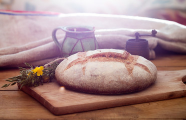 Freshly baked traditional bread on wooden table