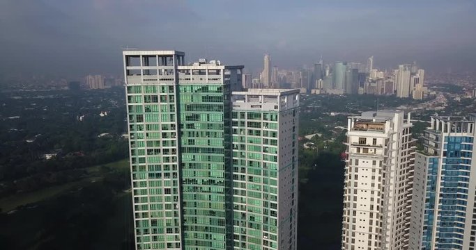 Ascending aerial flight over high rise building revealing metropolitan city beautiful skyline. Drone, 4K.