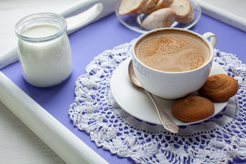 Breakfast served on lavender bed tray, yoghurt, cookies, bread