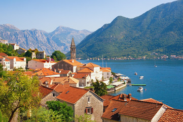 Naklejka na ściany i meble Beautiful Mediterranean landscape on sunny autumn day. Ancient town of Perast with bell tower of St. Nicholas Church. Montenegro, Adriatic Sea, Bay of Kotor
